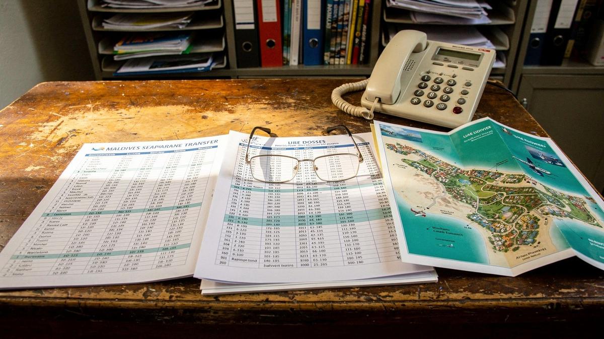 Printed route dossiers and maps on the desk at the jitmint.com office in Kyiv